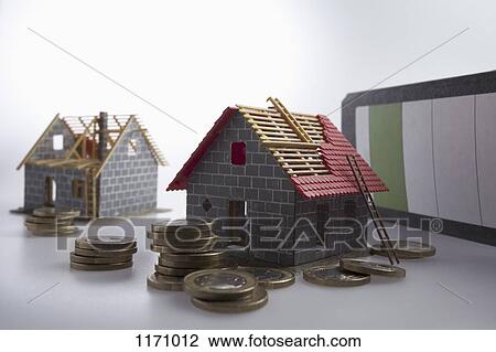 Two partially constructed models of a house with piles of European Union coins around them View Large Photo Image Stock Image - Two partially constructed models of a house with piles of European Union coins around them. Fotosearch