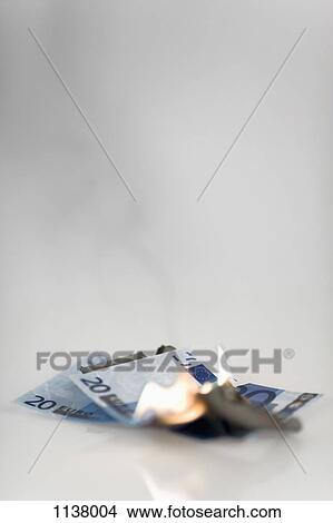 Two twenty euro banknotes on fire View Large Photo Image Picture - Two twenty euro banknotes on fire. Fotosearch