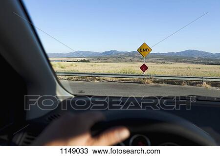 View through a car windshield of an END road sign and mountain ranges behind View Large Photo Image Stock Image - View through a car windshield of an END road sign and mountain ranges behind. Fotosearch