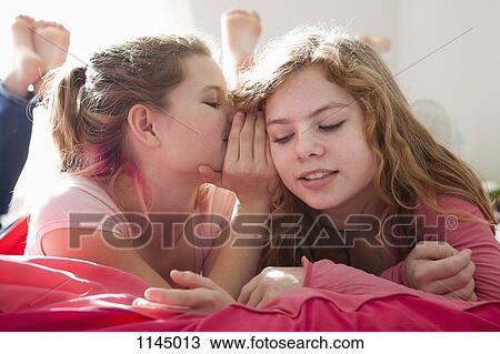 Whispering sisters View Large Photo Image Stock Image - Whispering sisters. Fotosearch
