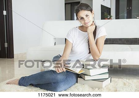Woman at home leaning on books reading View Large Photo Image Stock Image - Woman at home leaning on books reading. Fotosearch