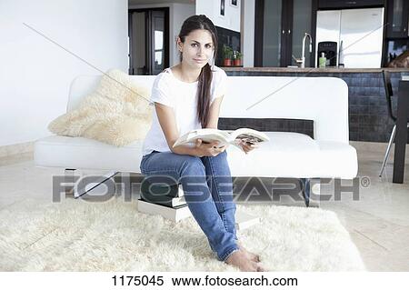 Woman at home sitting on books and reading View Large Photo Image Stock Photography - Woman at home sitting on books and reading. Fotosearch