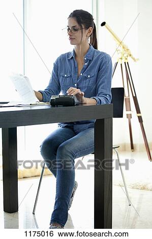Woman doing her finances View Large Photo Image Stock Photograph - Woman doing her finances. Fotosearch