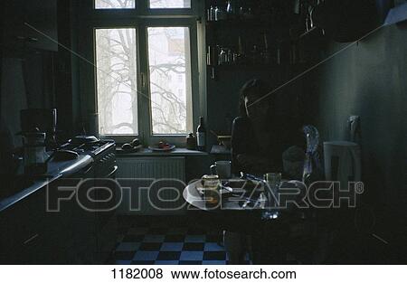 Woman in dark kitchen View Large Photo Image Stock Photo - Woman in dark kitchen. Fotosearch