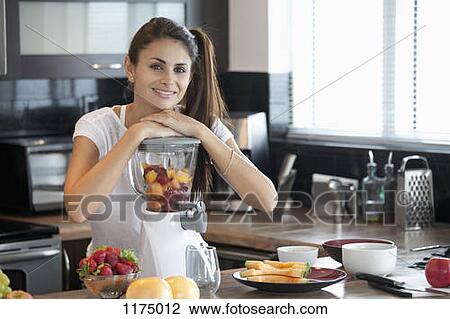 Woman leaning on blender full of fruit View Large Photo Image Stock Image - Woman leaning on blender full of fruit. Fotosearch