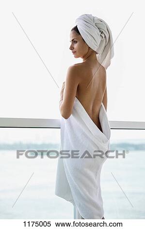 Stock Photography - Woman looking at sea view from balcony. Fotosearch
