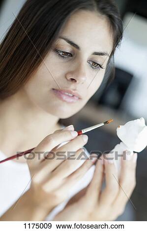 Woman painting a little bear ornament View Large Photo Image Stock Photo - Woman painting a little bear ornament. Fotosearch