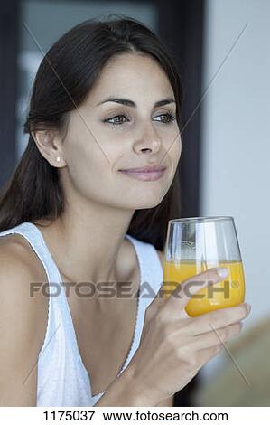 Woman with glass of fresh orange juice View Large Photo Image Stock Photo - Woman with glass of fresh orange juice. Fotosearch
