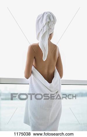 Woman wrapped in towel looking at sea view from balcony View Large Photo Image Stock Photo - Woman wrapped in towel looking at sea view from balcony. Fotosearch