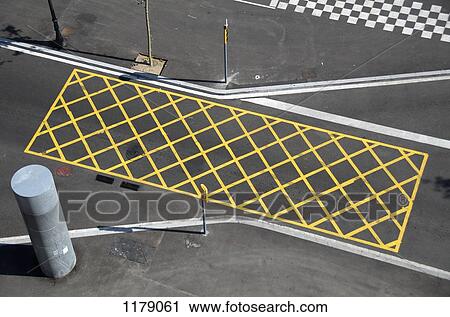 Yellow lines on the street to mark 'no-stopping area' near a red light/crossing View Large Photo Image Stock Image - Yellow lines on the street to mark 'no-stopping area' near a red light/crossing. Fotosearch