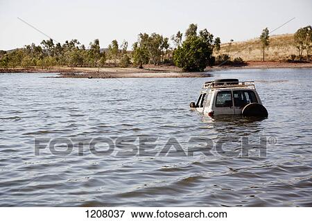 Stock Photo - A 4x4 driving through deep water. Fotosearch