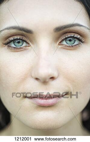 A beautiful woman staring serenely into the camera, close-up of face View Large Photo Image Stock Image - A beautiful woman staring serenely into the camera, close-up of face. Fotosearch