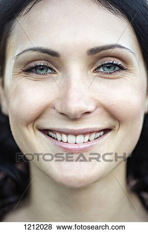 A beautiful young woman grinning into the camera View Large Photo Image Stock Photo - A beautiful young woman grinning into the camera. Fotosearch