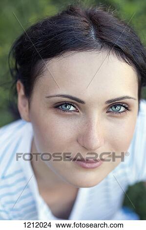 A beautiful young woman looking serenely into the camera View Large Photo Image Picture - A beautiful young woman looking serenely into the camera. Fotosearch