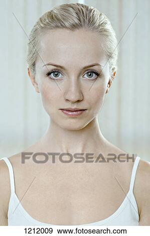 A beautiful young woman wearing a tank top and staring serenely View Large Photo Image Stock Photo - A beautiful young woman wearing a tank top and staring serenely. Fotosearch