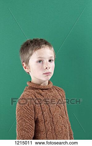 Stock Image - A boy looking seriously into the camera. Fotosearch