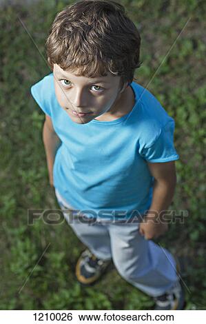 A boy looking sullenly up into the camera View Large Photo Image Stock Photograph - A boy looking sullenly up into the camera. Fotosearch