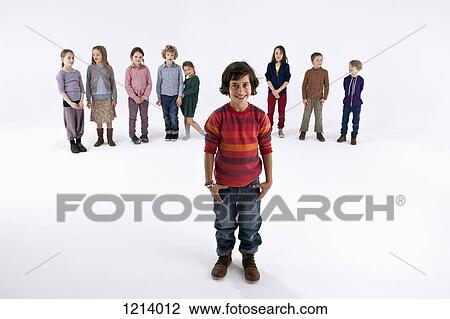 A boy standing in front of a line of kids View Large Photo Image Stock Image - A boy standing in front of a line of kids. Fotosearch