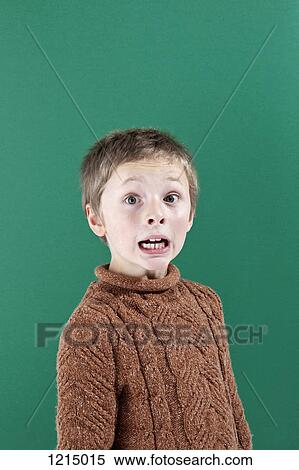Stock Photography - A boy with a shocked expression of fear on his face. Fotosearch