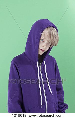 A boy with the hood of his sweatshirt up peeking shyly at the camera View Large Photo Image Stock Photo - A boy with the hood of his sweatshirt up peeking shyly at the camera. Fotosearch