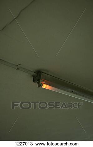 A broken fluorescent light emitting a faint orange light View Large Photo Image Stock Image - A broken fluorescent light emitting a faint orange light. Fotosearch