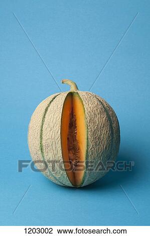 Stock Image - A cantaloupe with a slice removed. Fotosearch