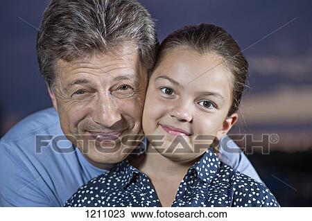 A cheerful father and his daughter smiling at the camera View Large Photo Image Stock Image - A cheerful father and his daughter smiling at the camera. Fotosearch