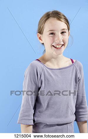 Picture - A cheerful girl smiling happily at the camera. Fotosearch