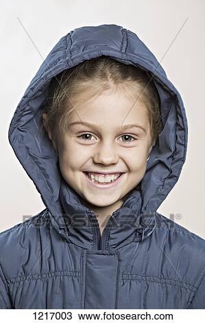 A cheerful young girl wearing a winter jacket View Large Photo Image Stock Image - A cheerful young girl wearing a winter jacket. Fotosearch