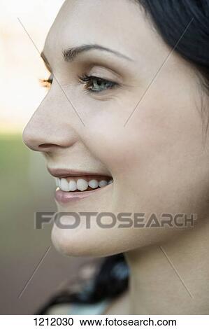 A cheerful young woman looking away View Large Photo Image Stock Image - A cheerful young woman looking away. Fotosearch