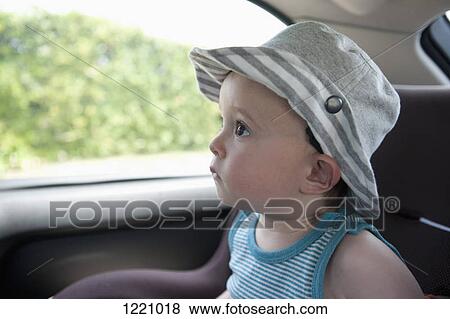 Stock Photo - A child anticipating a car ride, sitting in car seat. Fotosearch