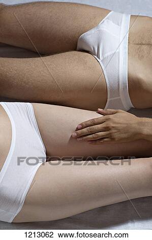 A couple lying side by side, close-up of hips and thighs View Large Photo Image Stock Image - A couple lying side by side, close-up of hips and thighs. Fotosearch