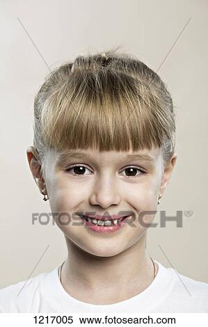 A cute cheerful young girl grinning into the camera View Large Photo Image Stock Photography - A cute cheerful young girl grinning into the camera. Fotosearch