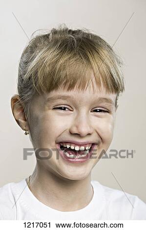 Stock Image - A cute laughing young girl. Fotosearch