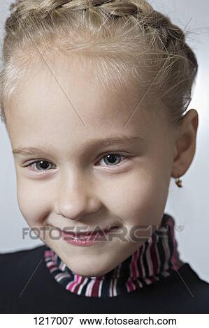 A fashionable young girl wearing earrings and her hair braided View Large Photo Image Stock Photo - A fashionable young girl wearing earrings and her hair braided. Fotosearch