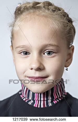 A fashionable young girl wearing earrings and her hair braided View Large Photo Image Stock Photo - A fashionable young girl wearing earrings and her hair braided. Fotosearch
