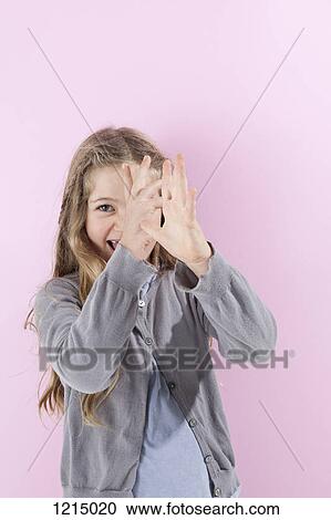 A girl gesturing with her hands playfully and laughing View Large Photo Image Stock Image - A girl gesturing with her hands playfully and laughing. Fotosearch