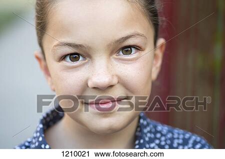 Stock Image - A girl smiling and looking into the camera. Fotosearch