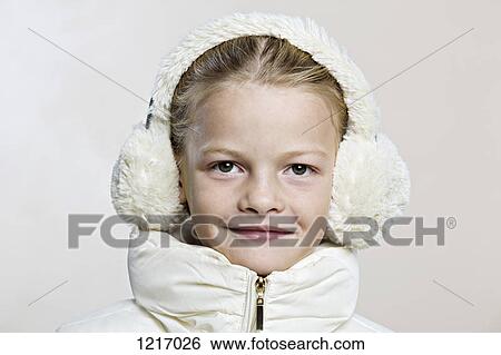 A girl wearing earmuffs and a winter jacket View Large Photo Image Stock Photograph - A girl wearing earmuffs and a winter jacket. Fotosearch
