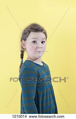 Picture - A girl with a look of excited surprise on her face. Fotosearch