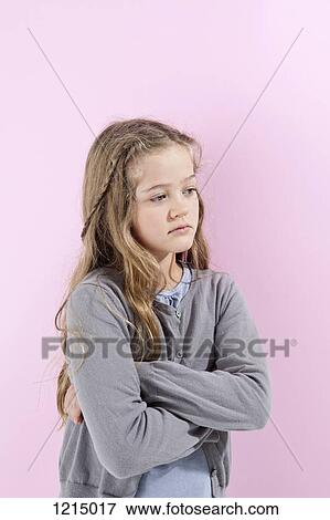 A girl with her arms crossed, looking away angrily View Large Photo Image Stock Photo - A girl with her arms crossed, looking away angrily. Fotosearch