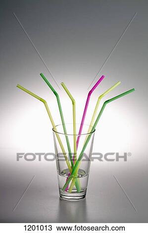 A glass with water in it and three yellow drinking straws, two green ones and one pink one View Large Photo Image Stock Image - A glass with water in it and three yellow drinking straws, two green ones and one pink one. Fotosearch