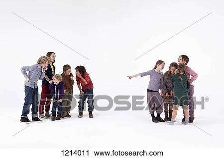 A group of boys laughing while a group of girls gossips about them View Large Photo Image Stock Image - A group of boys laughing while a group of girls gossips about them. Fotosearch