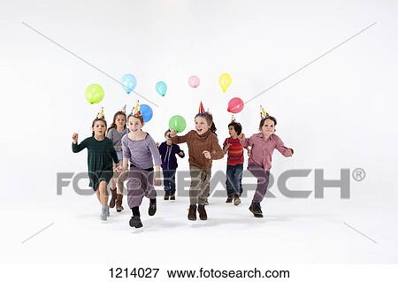 A group of kids in party hats and carrying balloons running forward View Large Photo Image Stock Photo - A group of kids in party hats and carrying balloons running forward. Fotosearch