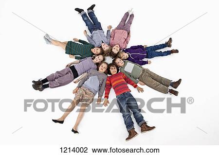 A group of kids lying on their backs in a circle View Large Photo Image Stock Image - A group of kids lying on their backs in a circle. Fotosearch