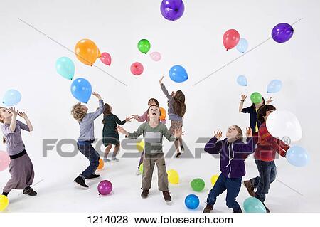 A group of kids playing with balloons View Large Photo Image Stock Photo - A group of kids playing with balloons. Fotosearch