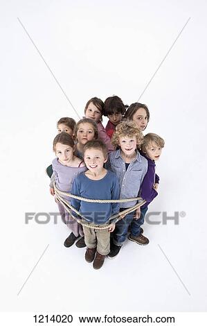 Stock Image - A group of kids tied together with a rope. Fotosearch