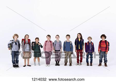 Stock Image - A group of school children wearing backpacks, standing in a row. Fotosearch