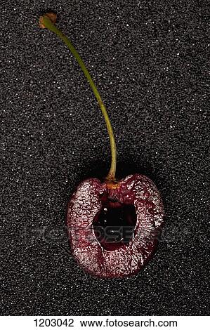 Stock Image - A half of a ripe Bing cherry. Fotosearch