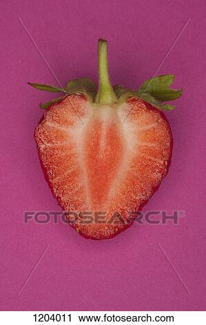A halved strawberry on a pink background View Large Photo Image Stock Image - A halved strawberry on a pink background. Fotosearch